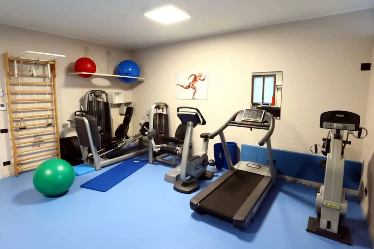 Sala di recupero motorio vista d'insieme, con spalliera, cyclette e tapis roulant